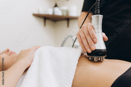 Cosmetologist. Lymphatic drainage massage LPG apparatus process. Woman getting massage in a beauty SPA salon. LPG, and body contouring treatment in clinic. photo