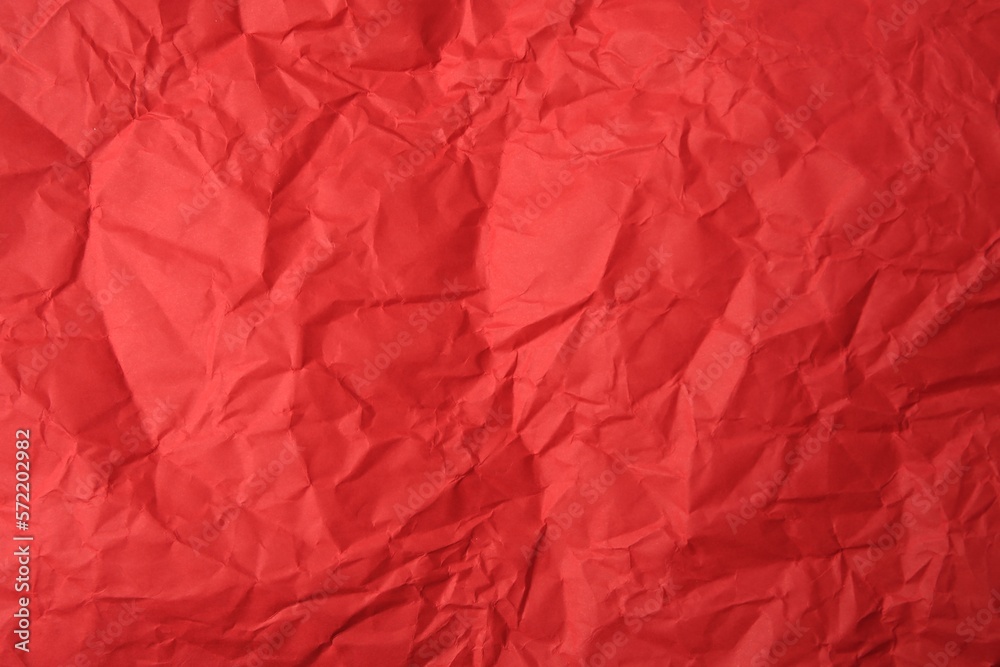 Sheet of crumpled red paper as background, top view Sheet of crumpled red paper as background, top view