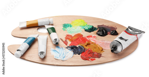 Wooden palette with oil paints on white background