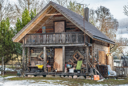 Beautiful old traditional wooden house in the village of Margionys, Dzūkija or Dainava region, Lithuania, in winter or spring photo