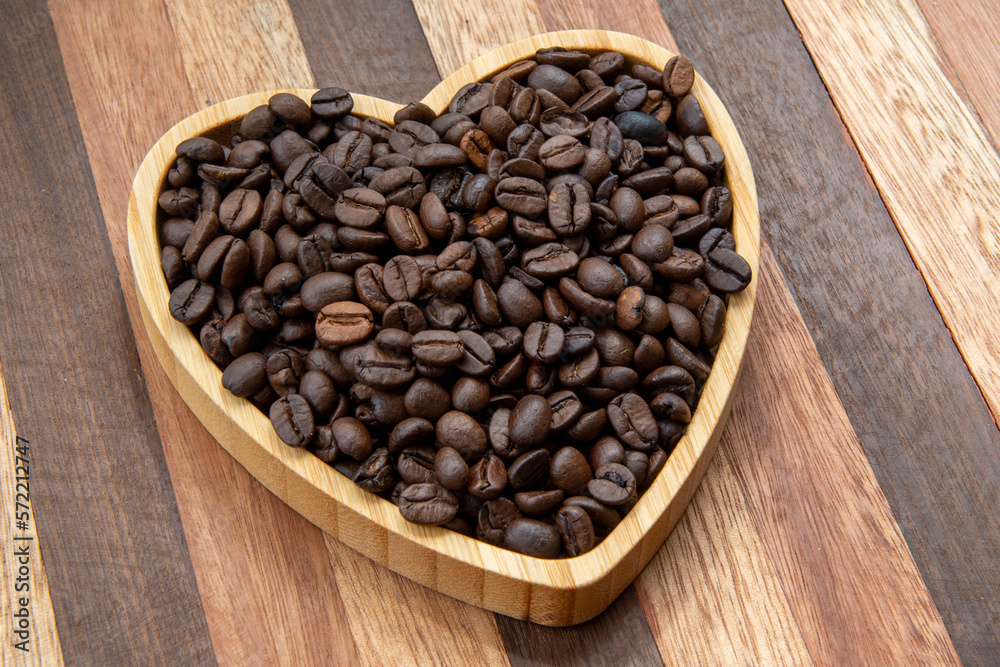 coffee beans in heart-shaped tra,y representing love of coffee coffee beans in heart-shaped tra,y representing love of coffee