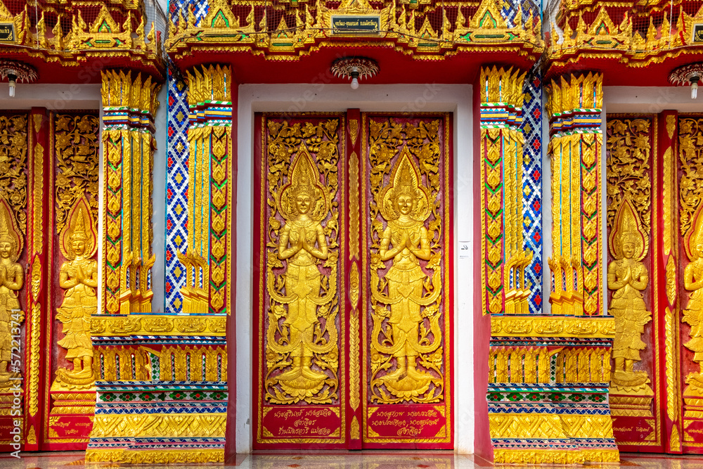Ornate detail on golden doors at a Buddhist temple in Mae Sot Thailand