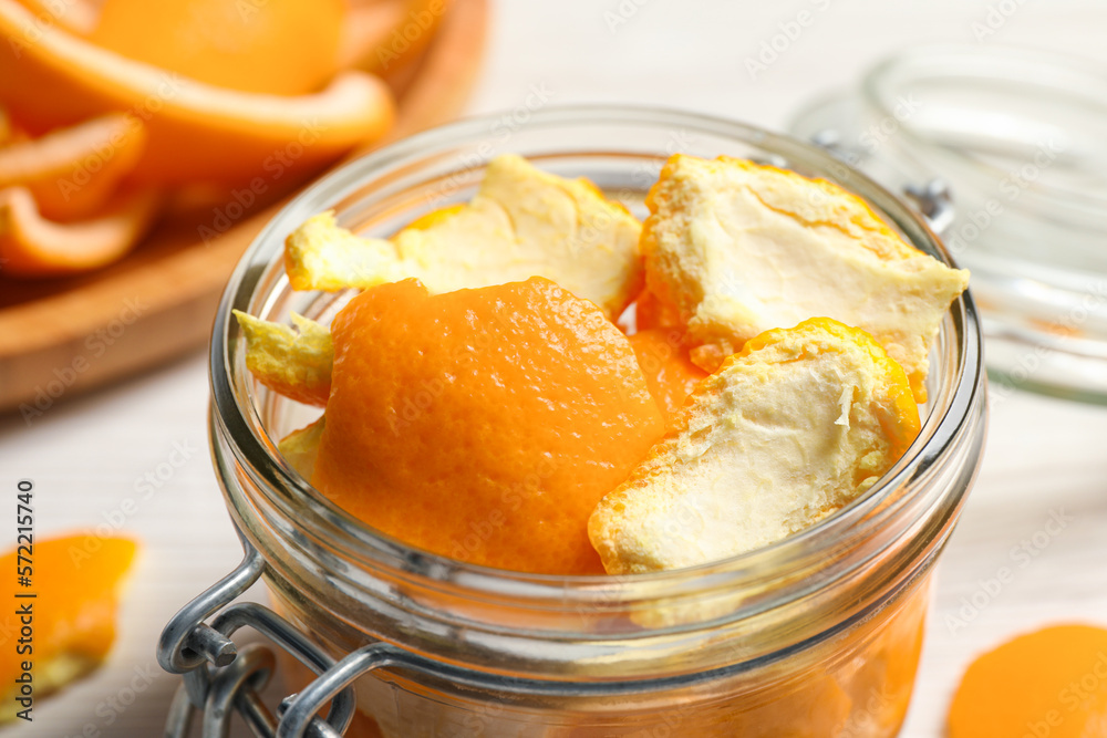 Orange peels preparing for drying on white wooden table, closeup Orange peels preparing for drying on white wooden table, closeup