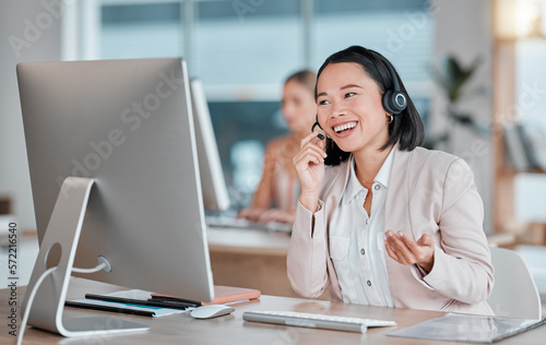 Asian woman, call center and computer in consultation for telemarketing, customer support or service at office desk. Happy female consultant smiling in contact us for desktop advice, help or sales