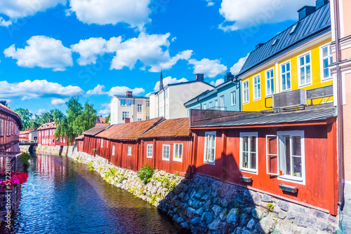 Foto Colorful houses by the canal in the city center of Vasteras, Sweden