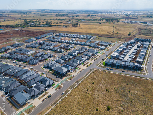 Aerial view of new houses in a subdivision bordering rural land photo