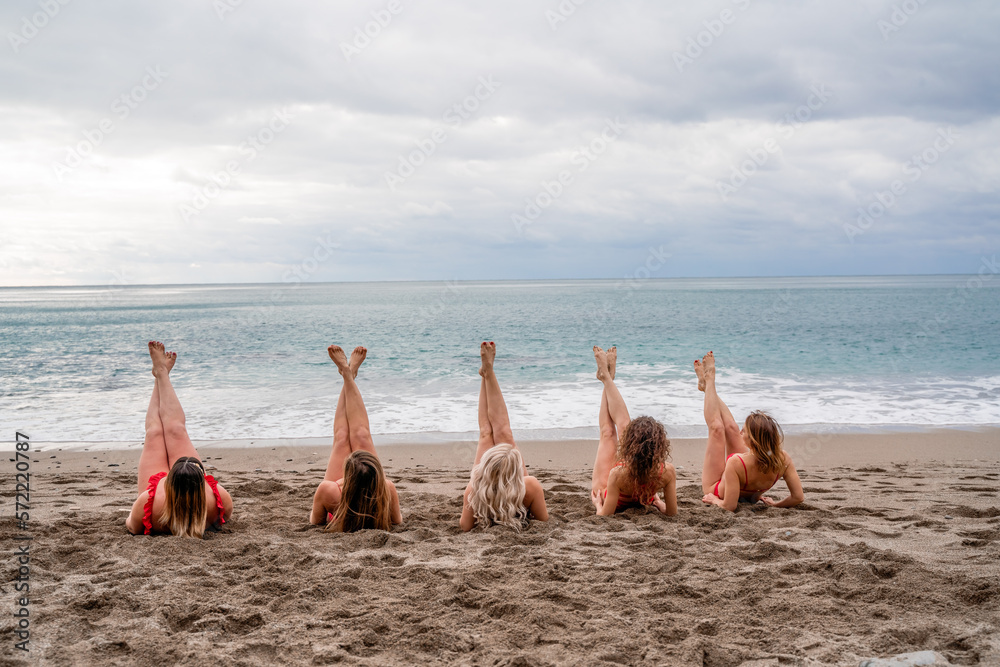 Fototapeta premium Big happy family or group of five friends is having fun against sunset beach. Beach holidays concept.