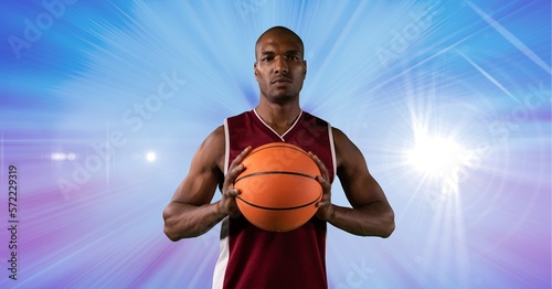 Composition of male basketball player holding basketball with copy space