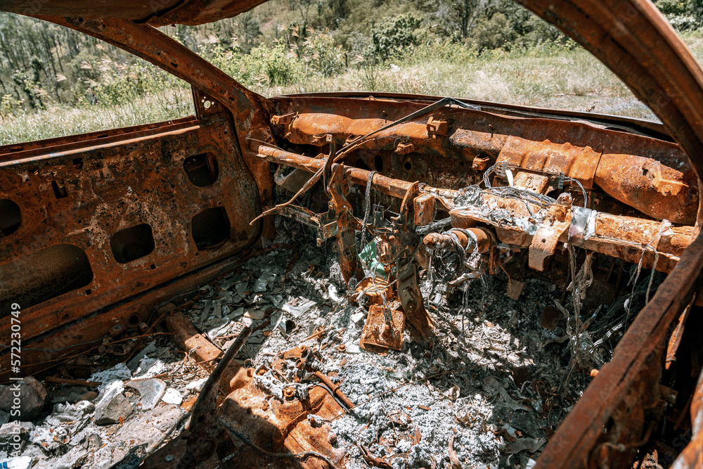 Burned down car left along the highway