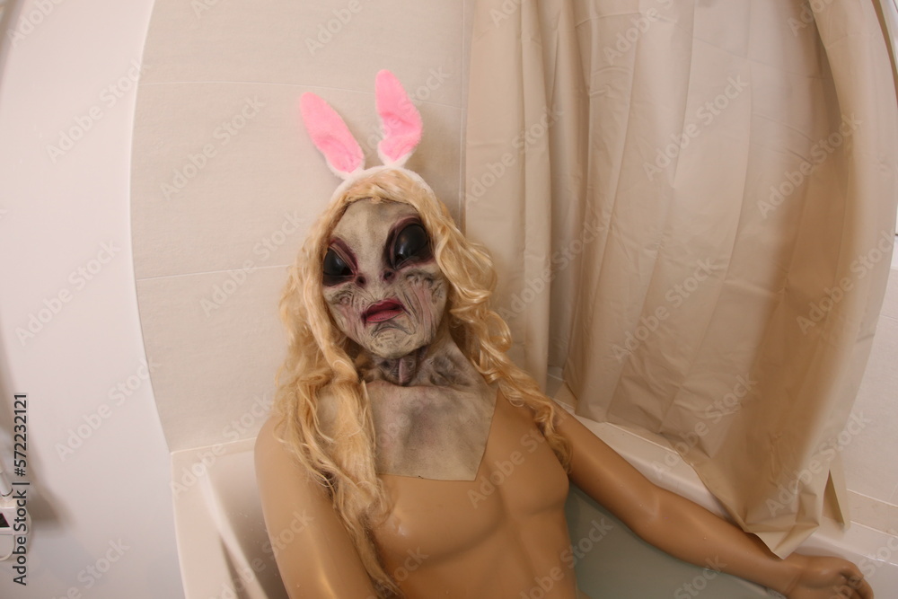 Spooky creature with bunny ears in the bathtub 