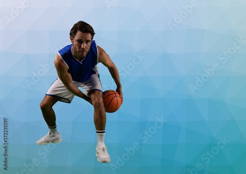 Composition of caucasian male basketball player with ball and copy space on blue background