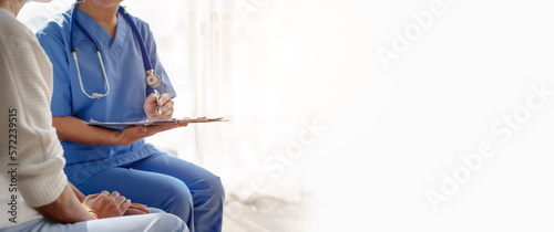 Fotografie Young asian caretaker with 60s asia elderly woman consulting and encourage, take