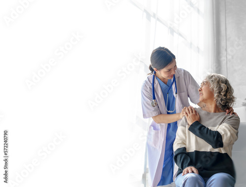 фотографія Young asian caretaker with 60s asia elderly woman consulting and encourage, take