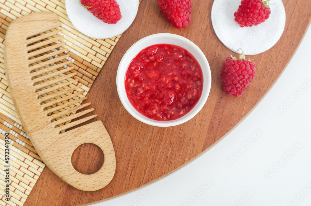 Raspberry mask (scrub) in a small white bowl. Homemade face or eye mask, natural beauty treatment and spa recipe. Copy space. Raspberry mask (scrub) in a small white bowl. Homemade face or eye mask, natural beauty treatment and spa recipe. Copy space.