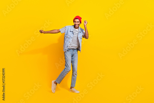 Full body photo of cheerful overjoyed person enjoy chilling dancing isolated on yellow color background