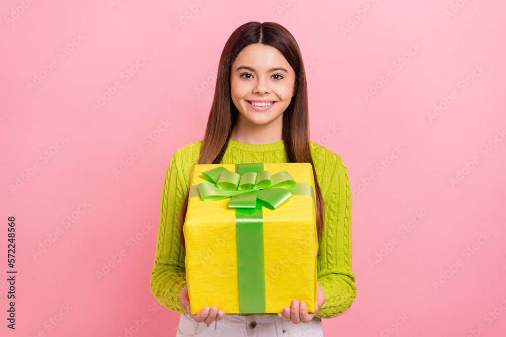 Photo portrait of cute young girl holding big yellow giftbox celebrate birthday wear trendy green outfit isolated on pink color background Photo portrait of cute young girl holding big yellow giftbox celebrate birthday wear trendy green outfit isolated on pink color background