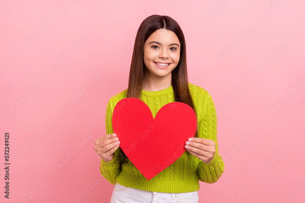 Photo of positive lovely person toothy smile arms hold red paper heart isolated on pink color background Photo of positive lovely person toothy smile arms hold red paper heart isolated on pink color background
