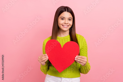 Photo of positive lovely person toothy smile arms hold red paper heart isolated on pink color background © deagreez