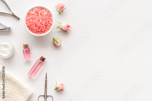 Hands and nail care spa set with pink roses flowers. Beauty care salon spa.