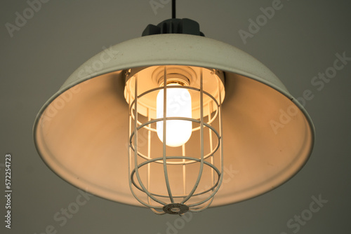 Iron lighting lamp in classic style is glowing in warming shade ligth. Interior decoration object  selective focus.