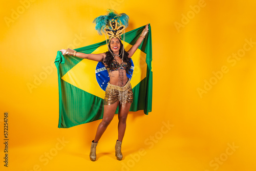 Horizontal photo, full body, Black Brazilian woman in carnival clothes. with brazil flag. photo