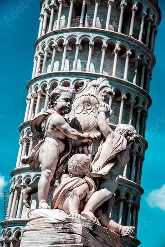 Obraz na płótnie Monument on the background of the famous sloping tower with columns in Pisa, Italy. fascinating exotic amazing places. w salonie