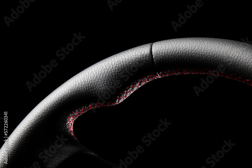 High-quality, detailed photo of a freshly repaired leather steering wheel with a black background and studio lighting. Perfect for automotive, fashion, and design industries. photo