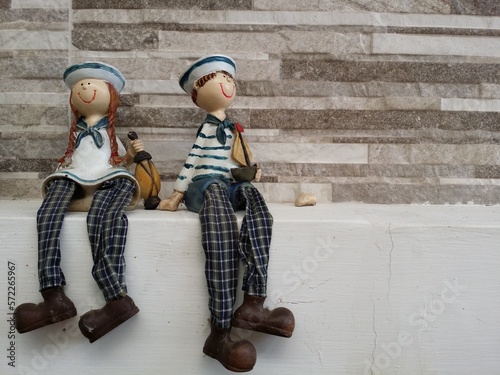boy and girl ceramic doll in navy dress sitting decoration the garden