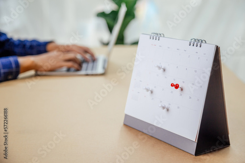 Calendar desk place on the table. Desktop Calender for Planner to plan agenda, timetable, appointment, organization, management each date, month, and year on wooden office table. Calendar Concept.