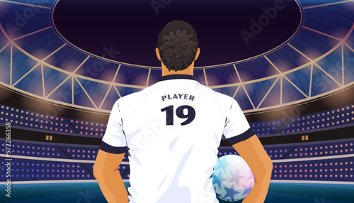 Rear view of a soccer player holding a football in a stadium 