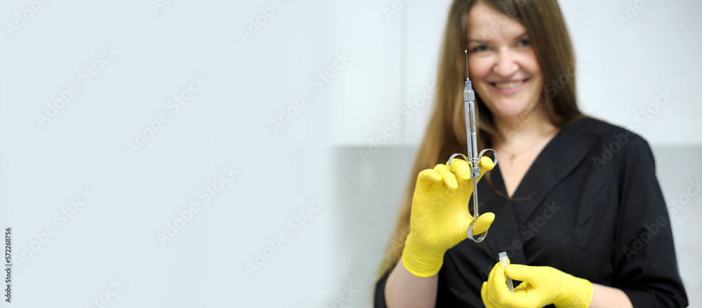 Doctor, girl, syringe injection Young girl woman with syringe in hand anaesthesia yellow gloves doctor nurse Black clothes long flowing hair white cabinet office dentistry Doctor, girl, syringe injection Young girl woman with syringe in hand anaesthesia yellow gloves doctor nurse Black clothes long flowing hair white cabinet office dentistry