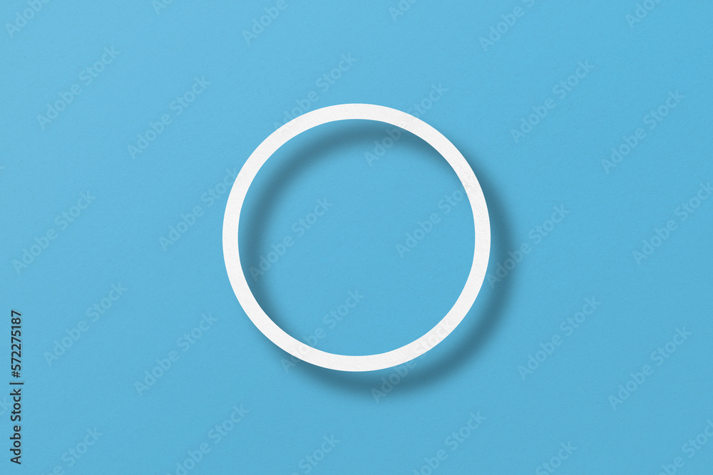 paper cut into circle shape with light and shadow Placed on a light blue paper background. paper cut into circle shape with light and shadow Placed on a light blue paper background.