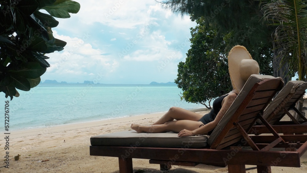 Young woman on vacation enjoying sea view in luxury hotel by beach
