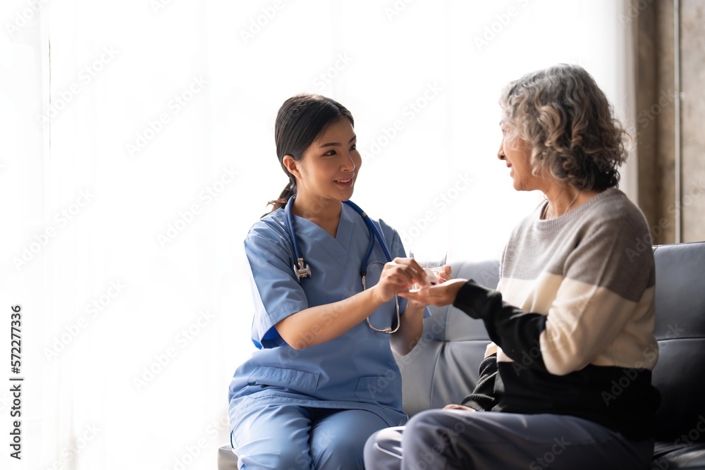 Healthcare worker or nurse caregiver giving pills, showing a prescription drug to senior woman. Elderly healthcare concept Healthcare worker or nurse caregiver giving pills, showing a prescription drug to senior woman. Elderly healthcare concept