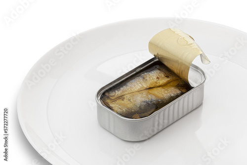 Opened sardine preserve fish can on a white plate. Isolated on a transparent background photo