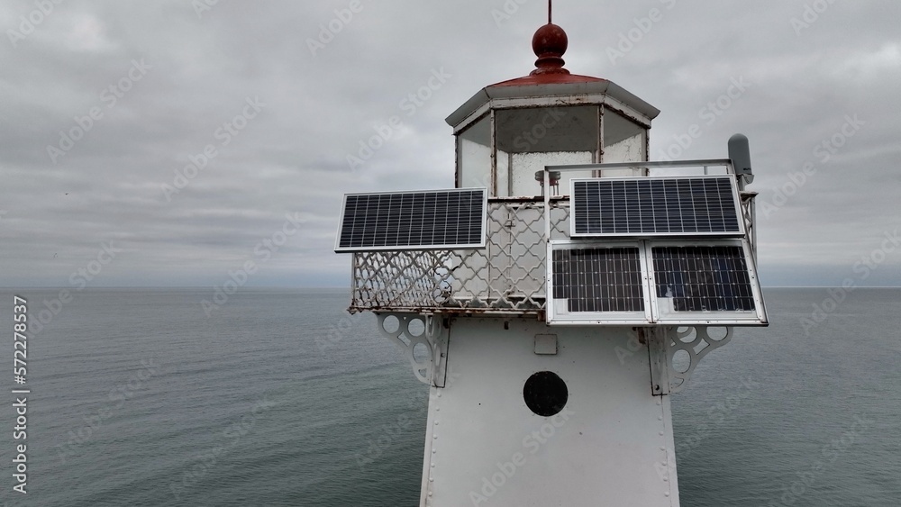 Historic Lighthouse at Sodus Bay New York by Lake Ontario during Winter under grey skies
