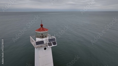 Historic Lighthouse at Sodus Bay New York by Lake Ontario during Winter under grey skies photo