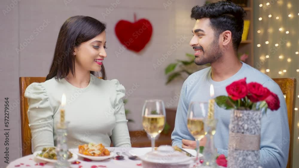 Happy romantic young man by holding girlfriend hand looking at camera - concept of relationship, valentine day celebration and affectionate. Happy romantic young man by holding girlfriend hand looking at camera - concept of relationship, valentine day celebration and affectionate.