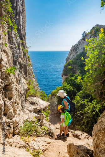 Gagliano del Capo, Salento. Mum and daughter follow the naturalistic path that from the Ciolo bridge leads to the spectacular Cipolliane caves, where you can admire a beautiful panorama of the sea.