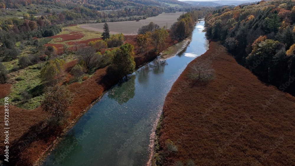 Beautiful creek stream in mountain valley during Autumn with Fall colors Beautiful creek stream in mountain valley during Autumn with Fall colors