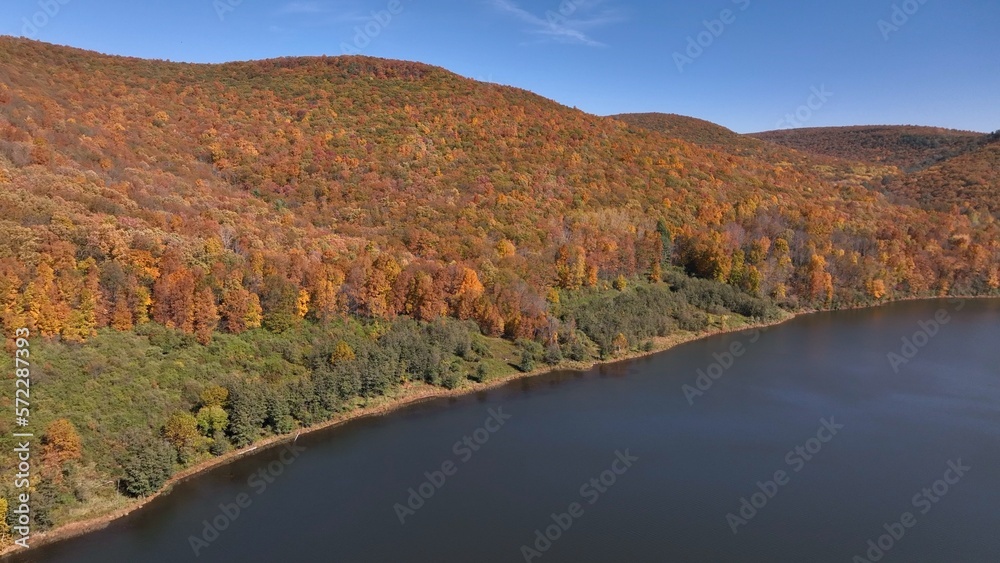 Mountains in Autumn with Fall colors in trees under blue sky in nature outdoors in American wilderness