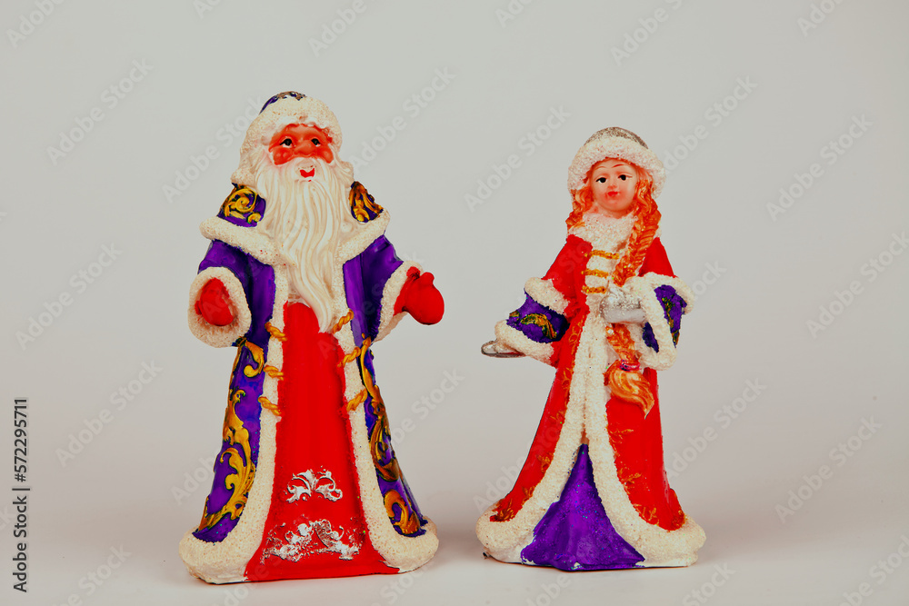 Christmas card with Santa Claus, Snow Maiden.pine and Christmas tree. cones and accessories. tinsel.A statuette of Santa Claus.Toys for the Christmas tree. Space for text.On a white background
