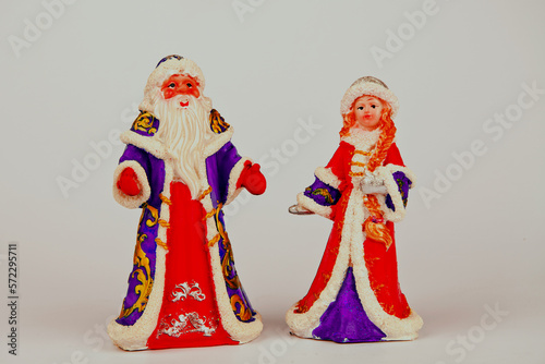 Christmas card with Santa Claus, Snow Maiden.pine and Christmas tree. cones and accessories. tinsel.A statuette of Santa Claus.Toys for the Christmas tree. Space for text.On a white background 