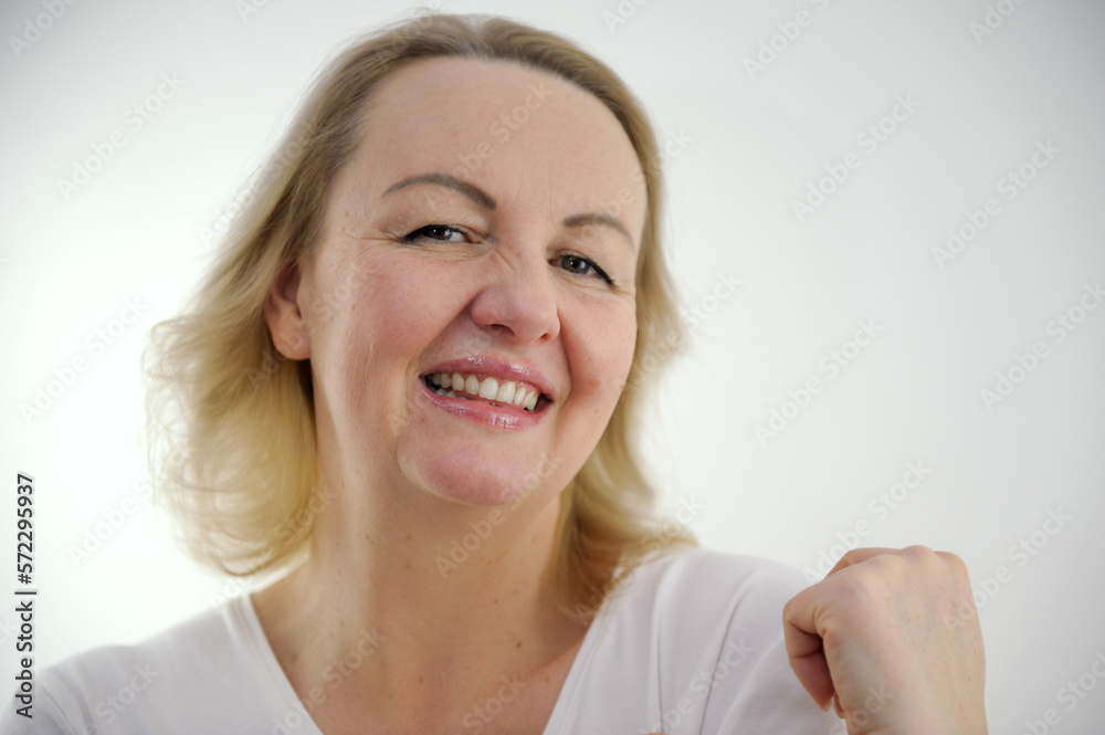 tenderness pleasure on face of sly look of middle-aged woman sincere smile raised one shoulder up looks askance coquetry pretty woman on white background pleasant product purchase excellent emotion tenderness pleasure on face of sly look of middle-aged woman sincere smile raised one shoulder up looks askance coquetry pretty woman on white background pleasant product purchase excellent emotion