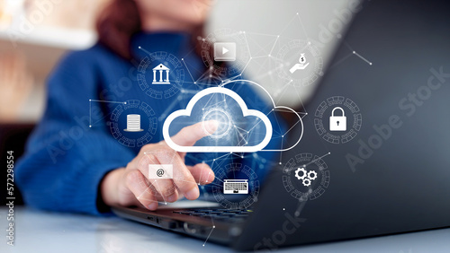 Woman uploading and transferring data from computer to cloud computing. Digital technology concept, data sheet management with large database capacity and high security.