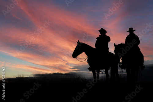 Two mounted cowboy silhouettes