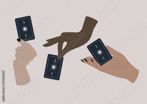 Hands holding tarot cards with celestial patterns