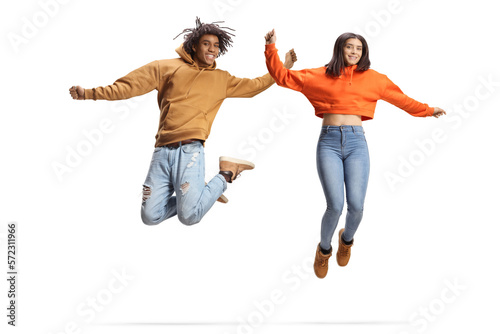 Happy african american guy and a caucasian female jumping and smiling