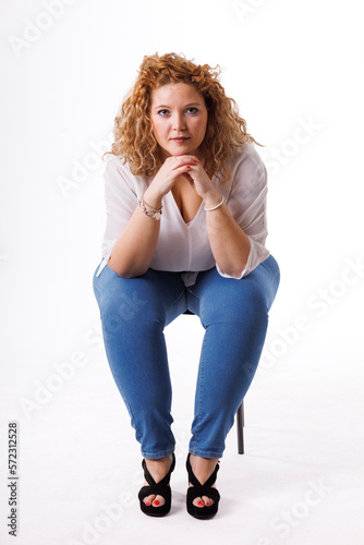 Plus size fashion model, fat woman in denim clothes and white shirt on white background, overweight female body