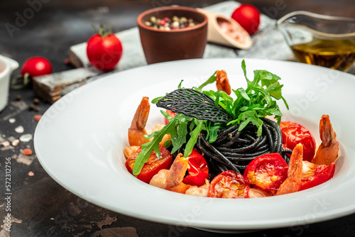 black pasta with shrimp and cherry tomatoes. Delicious balanced food concept, banner, menu, recipe place for text, top view